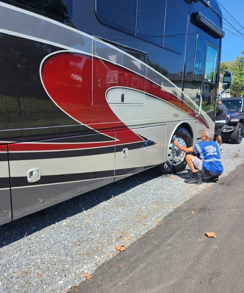 Side view of the motorhome being detailed by Pinnacle at the curb.