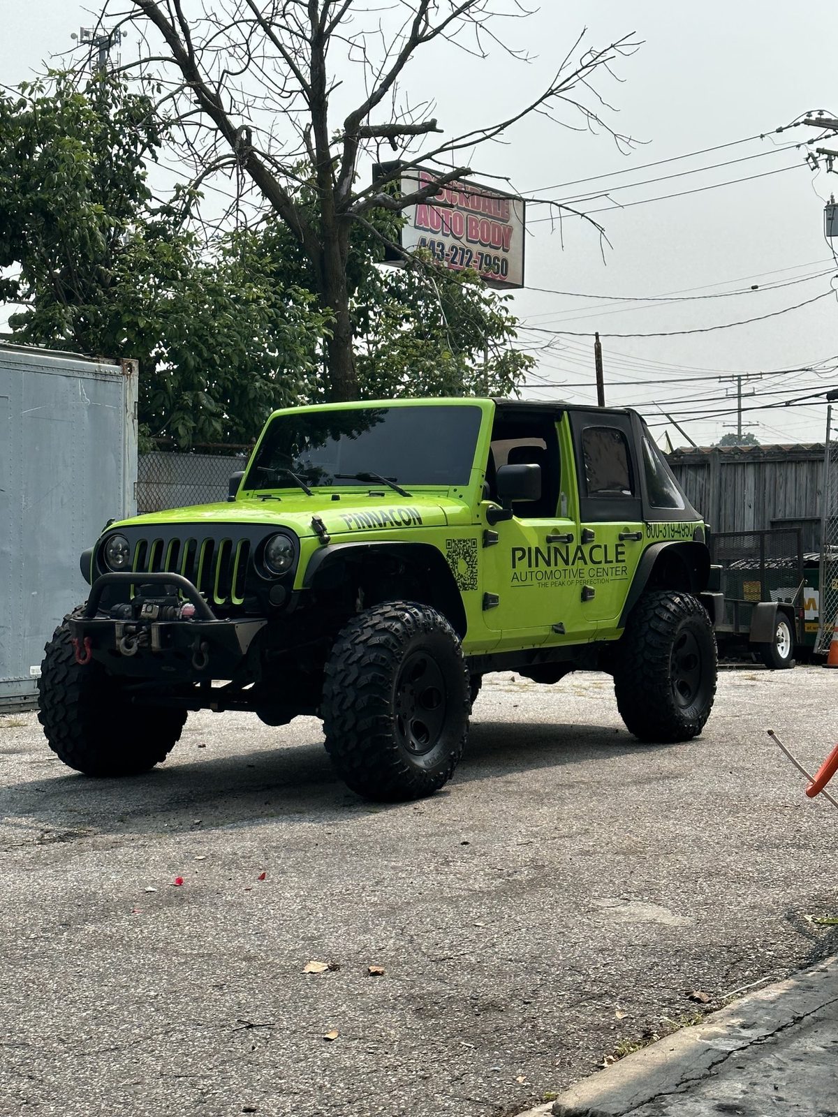 The lifted Pinnacle Jeep Wrangler on oversized tires, front three-quarter view